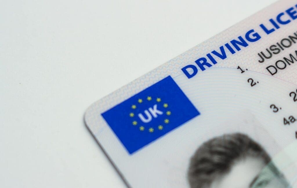 Detailed photo of a UK driving license showcasing EU flag and identity features.